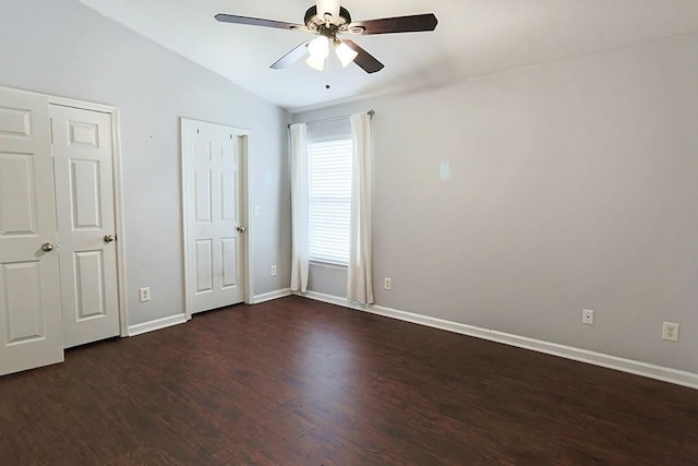 unfurnished bedroom featuring ceiling fan, vaulted ceiling, and dark hardwood / wood-style floors