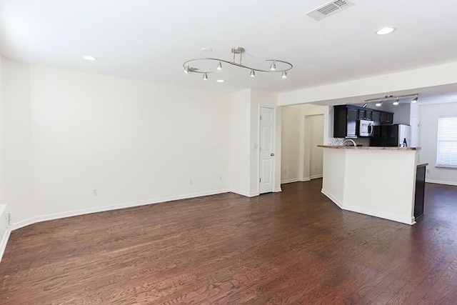 unfurnished living room featuring dark wood-type flooring