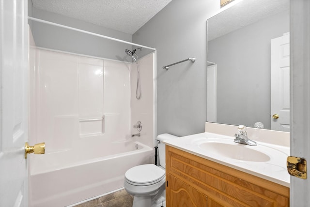 full bathroom featuring bathtub / shower combination, toilet, tile patterned floors, vanity, and a textured ceiling