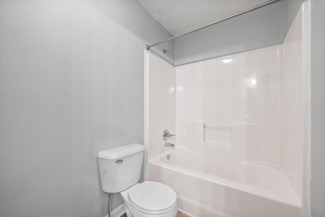 bathroom with toilet, a textured ceiling, and  shower combination