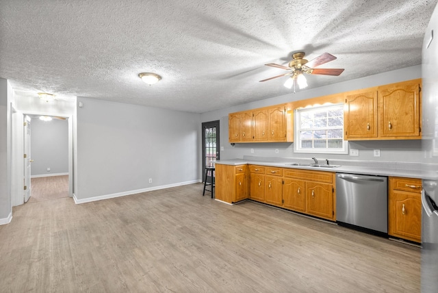 kitchen with sink, ceiling fan, light wood-type flooring, and dishwasher