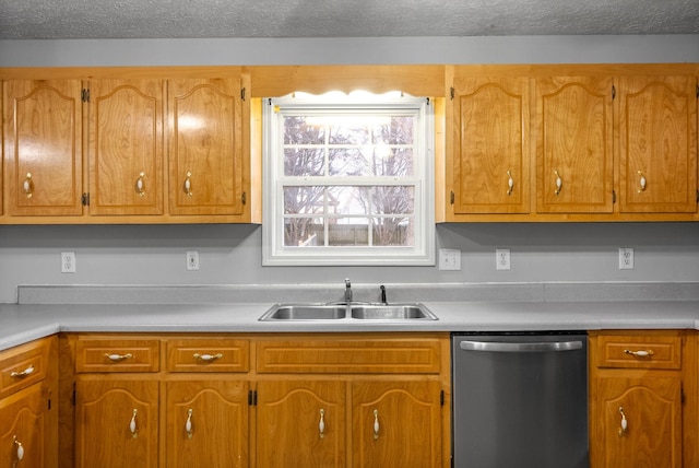 kitchen with a textured ceiling, dishwasher, and sink