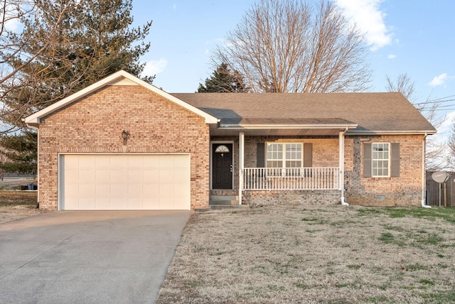 ranch-style home featuring a garage and covered porch