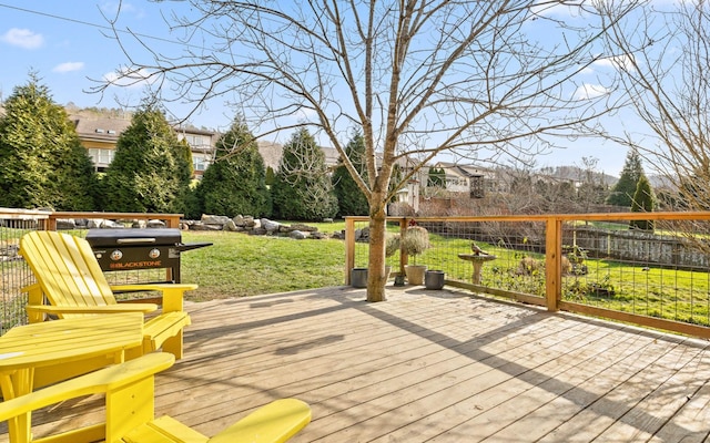 wooden terrace featuring a yard