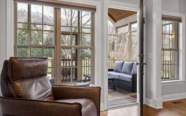 doorway to outside featuring a healthy amount of sunlight and hardwood / wood-style flooring