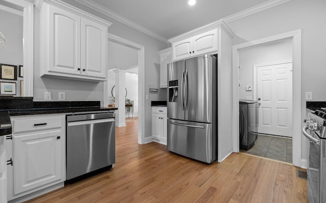 kitchen with white cabinets, stainless steel appliances, light wood-type flooring, and ornamental molding