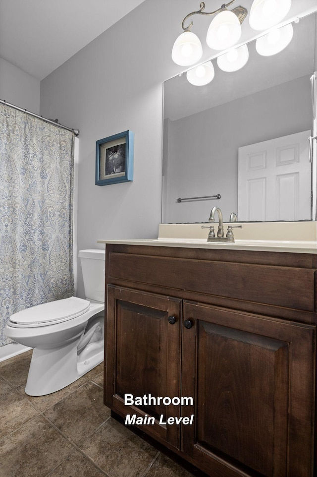 bathroom featuring toilet and vanity