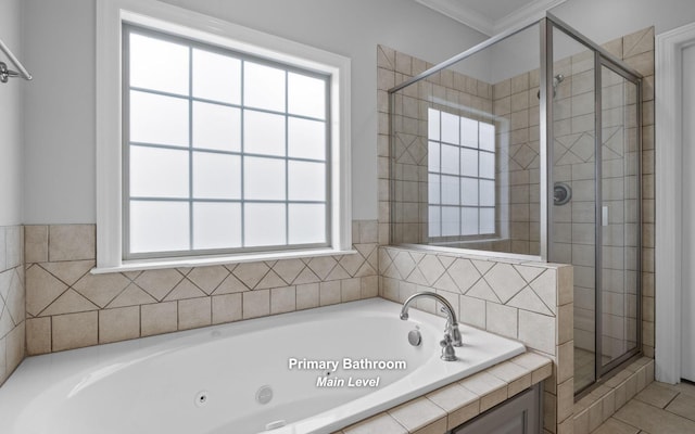 bathroom featuring ornamental molding, a healthy amount of sunlight, and shower with separate bathtub