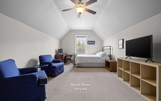 carpeted bedroom with ceiling fan and vaulted ceiling