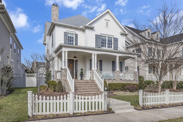 front facade with a porch and a front yard