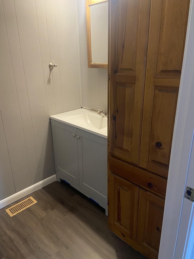 bathroom with vanity and hardwood / wood-style flooring