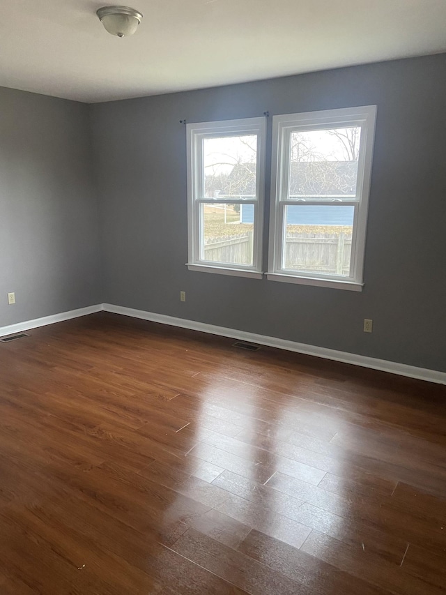 spare room with dark wood-type flooring