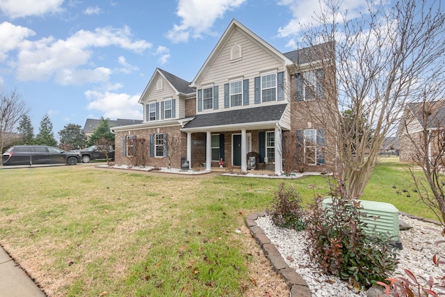 view of front facade featuring covered porch and a front lawn