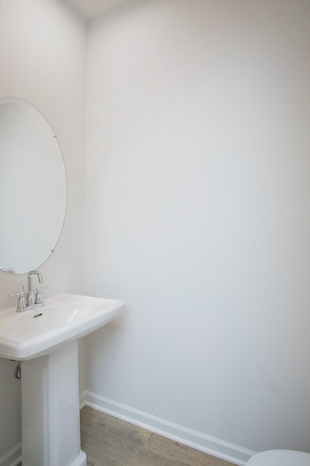 bathroom with hardwood / wood-style flooring and sink