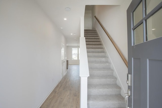 stairway with hardwood / wood-style flooring