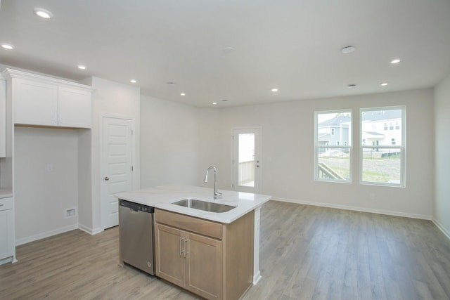 kitchen featuring sink, dishwasher, an island with sink, and white cabinets