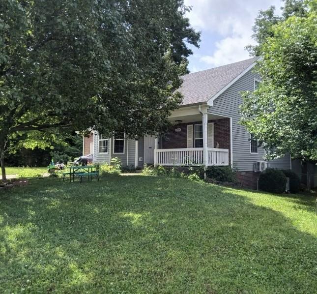 obstructed view of property featuring a porch and a front yard