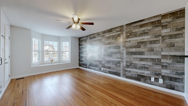 unfurnished room featuring ceiling fan and light hardwood / wood-style flooring