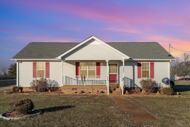 single story home with a yard and a porch