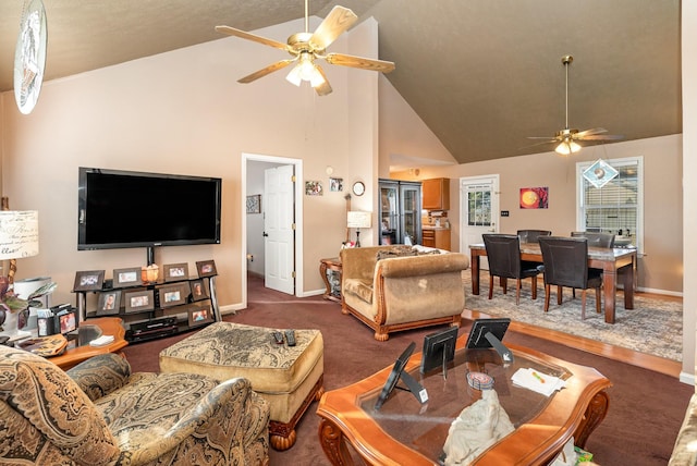 living room featuring high vaulted ceiling, dark colored carpet, and ceiling fan