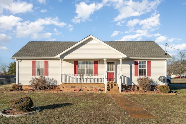 single story home featuring covered porch and a front yard