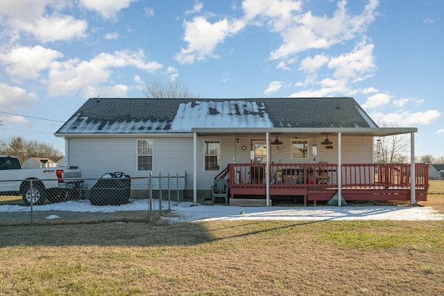 back of property with a lawn and covered porch