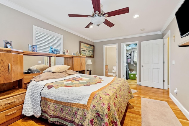 bedroom featuring a closet, ceiling fan, crown molding, and a spacious closet