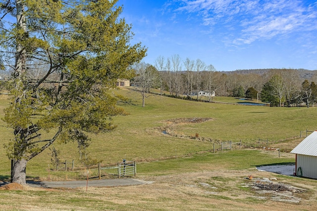 view of home's community with a rural view and a lawn