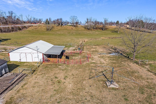 view of yard featuring an outbuilding and a rural view