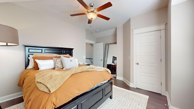 bedroom with vaulted ceiling, ceiling fan, and dark hardwood / wood-style flooring