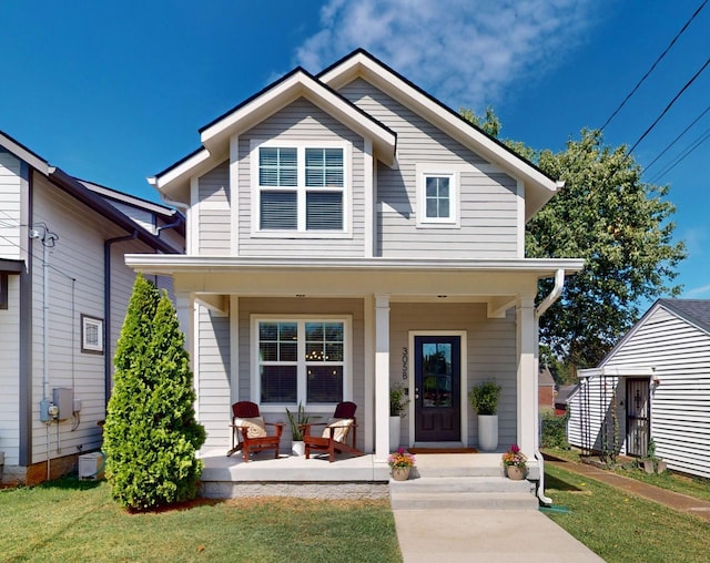 view of front of home with a front yard and covered porch