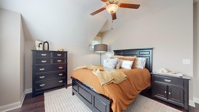 bedroom featuring ceiling fan, dark hardwood / wood-style flooring, and vaulted ceiling