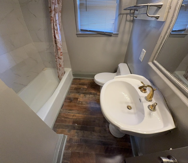 bathroom featuring toilet, wood-type flooring, walk in shower, and sink