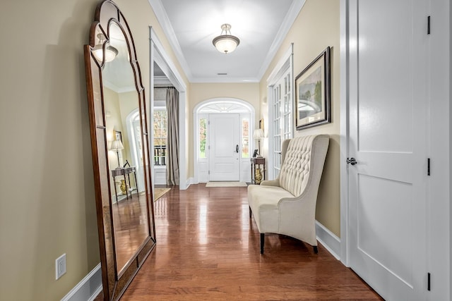 doorway to outside with hardwood / wood-style floors and crown molding