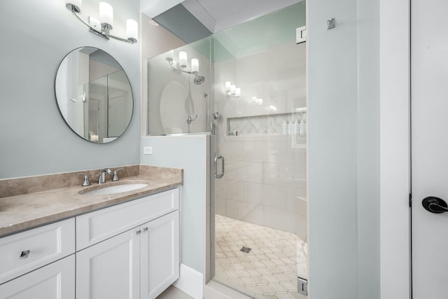 bathroom with a shower with door and vanity