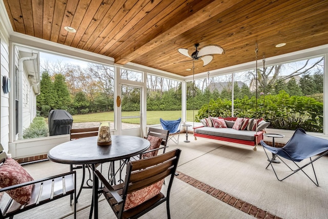 sunroom / solarium with ceiling fan and wooden ceiling