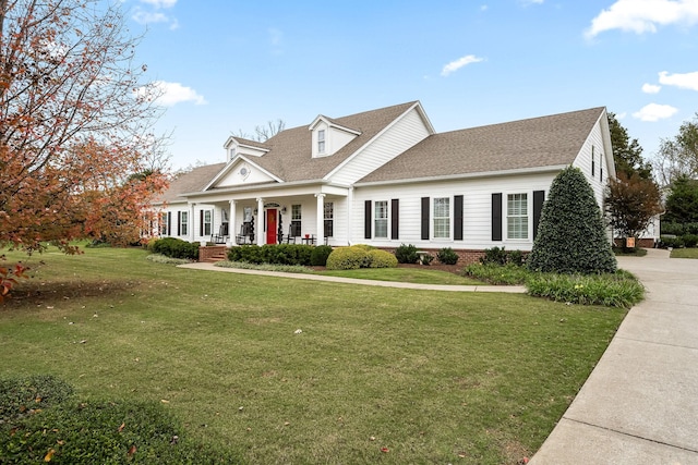 cape cod-style house featuring covered porch and a front lawn