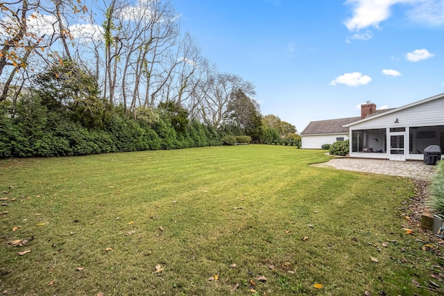 view of yard with a patio and a sunroom