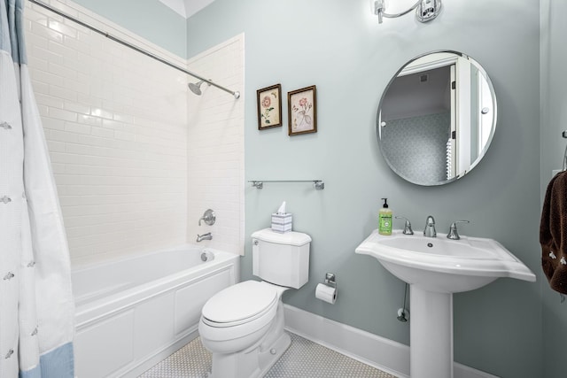 bathroom with toilet, tile patterned flooring, and shower / bath combo