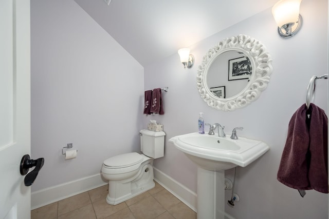 bathroom featuring sink, vaulted ceiling, tile patterned floors, and toilet