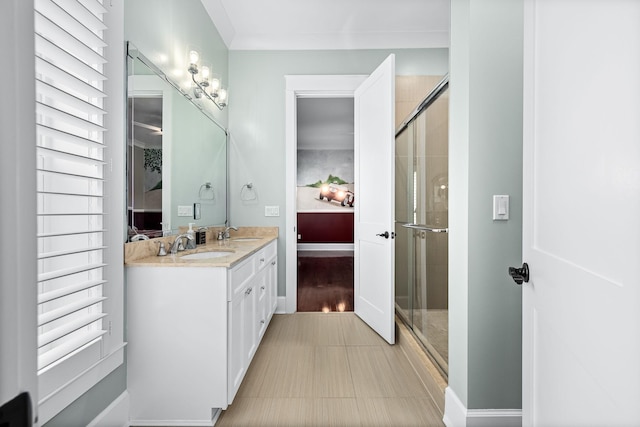 bathroom featuring an enclosed shower, vanity, and a healthy amount of sunlight