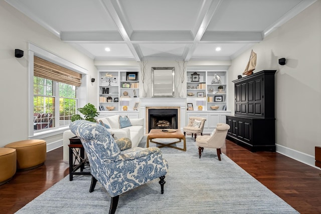 sitting room with beamed ceiling, built in shelves, dark wood-type flooring, and coffered ceiling