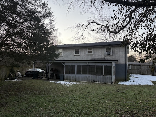 back of house featuring a yard and a sunroom