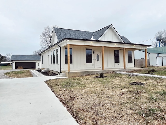 modern farmhouse featuring a garage and a porch