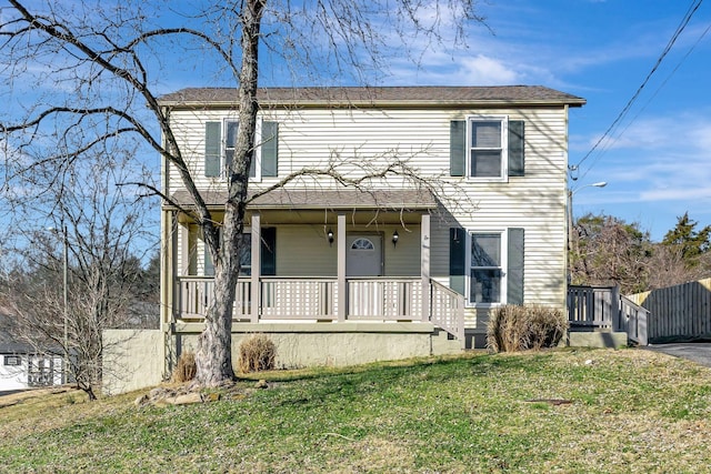 view of front of home featuring covered porch and a front lawn