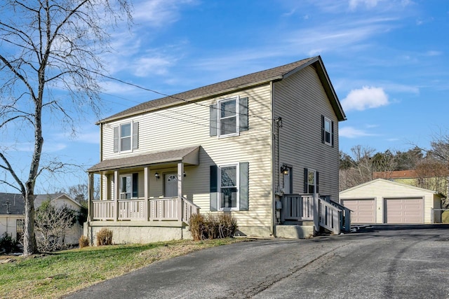 view of front of house featuring an outbuilding, covered porch, and a garage