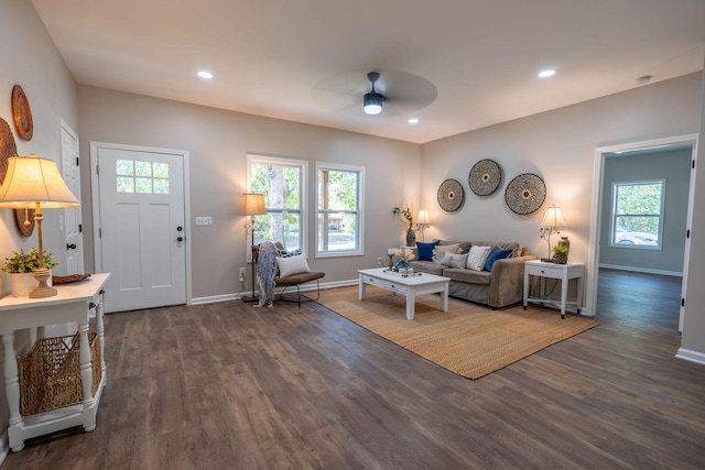 living room featuring ceiling fan, dark hardwood / wood-style flooring, and a wealth of natural light