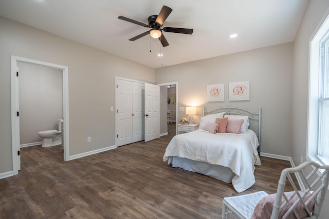 bedroom featuring dark wood-type flooring, ceiling fan, a closet, and connected bathroom