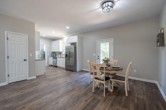 dining space with dark hardwood / wood-style flooring