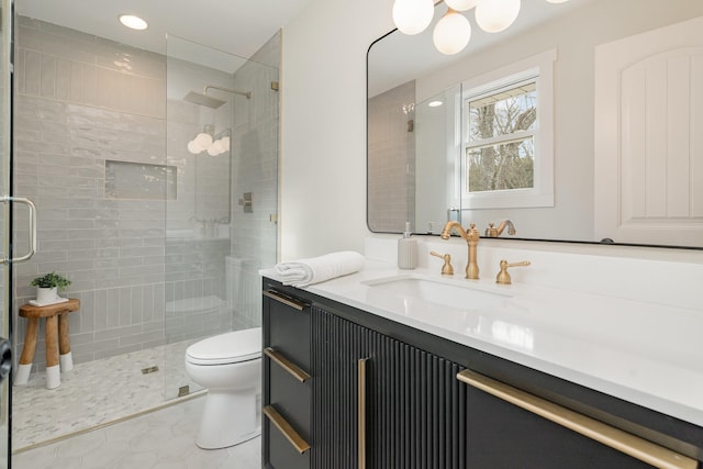 bathroom featuring a shower with door, tile patterned flooring, vanity, and toilet